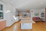 The kitchen features a large butcher block island to prepare your families meals 